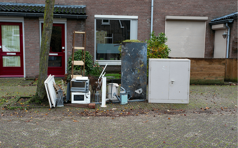 Abandoned household items outside a house